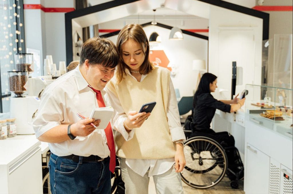 Two people looking at iphone